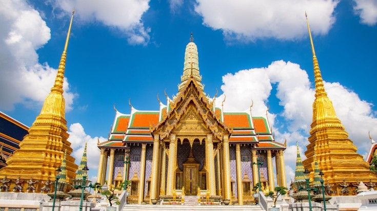 Wat Phra Kaew Temple of the Emerald Buddha on the cloudy blue sky day. Wat Phra Kaew Temple of the Emerald Buddha on the cloudy blue sky day.
