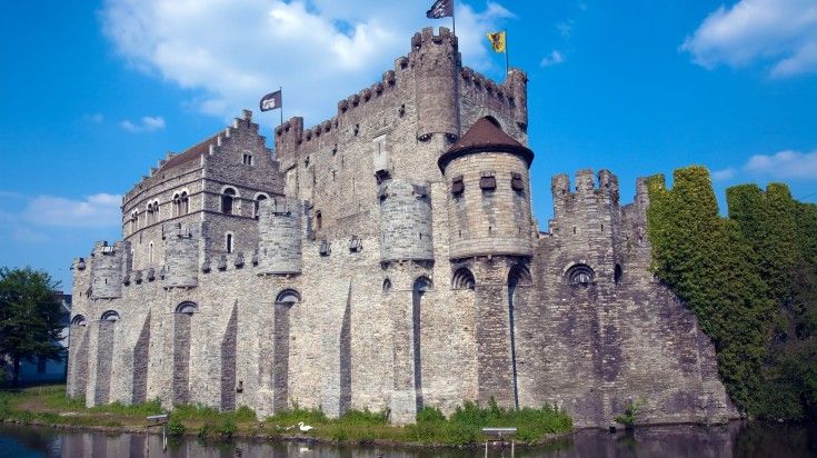 Gravensteen castle on a clear day and its reflection in still water in Belgium. 