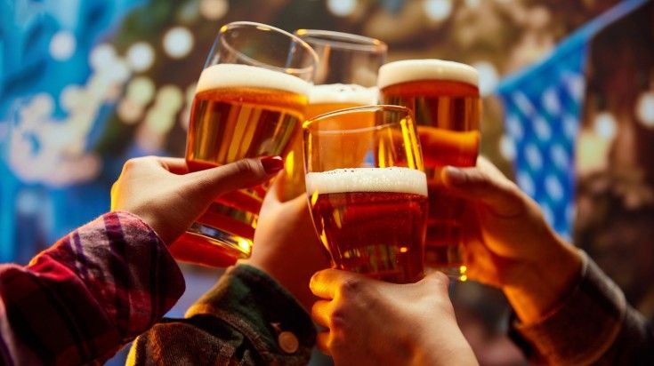 A gorup of people clinking the glasses of beer in Wiener Wiesn-Fest in Vien