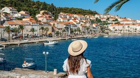A tourist girl enjoying the view of Korcula Town on a sunny day during her 10 days in Croatia.