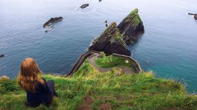 A girl admiring the beauty of Dingle Peninsula during her 10 days in Ireland.