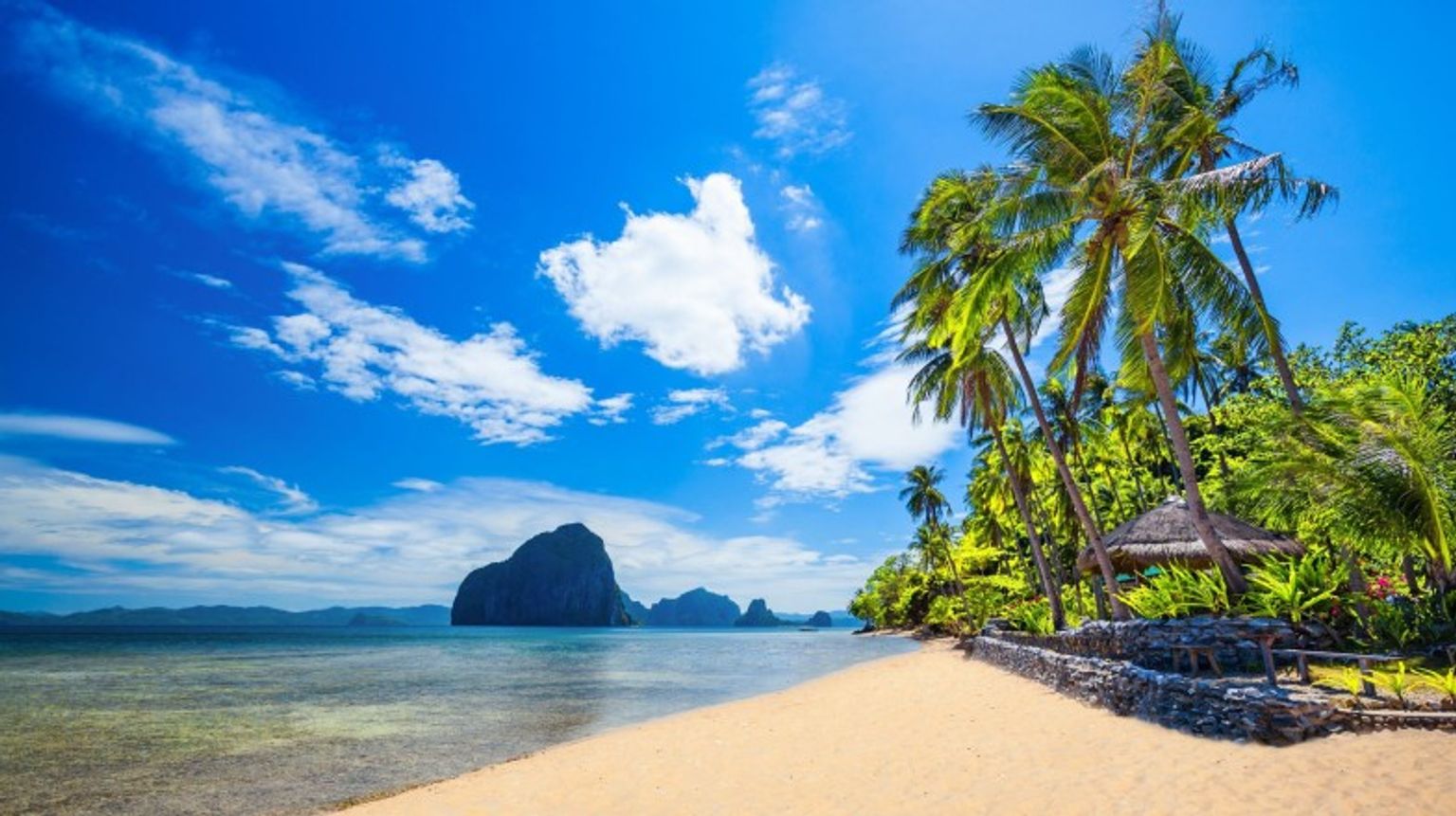 Relax on a beach at Palawan while spending 10 days in The Philippines.