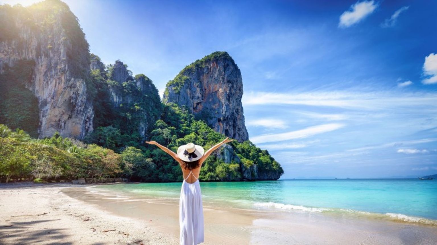 A girl with open arms at Railay in Krabi Beach during her 12 days in Thailand.