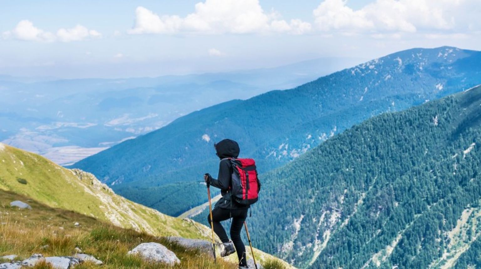 A woman hiking in Pirin mountain on a clear day during her 5 days in Bulgaria.