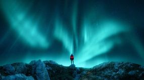 A woman admiring the beauty of the Northern Lights in Lapland during her 5 days in Norway.