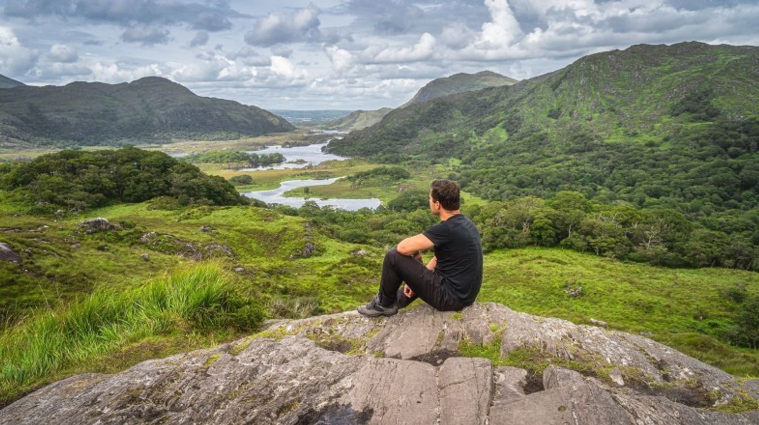 A man admiring the beauty of Ring of Kerry in Ireland in April.