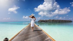 A woman walking in the wooden pier in Male during her 6 days in the Maldives.