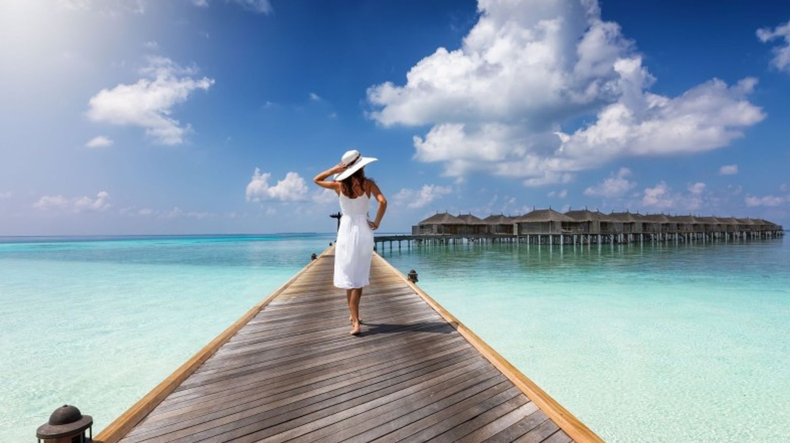 A woman walking in the wooden pier in Male during her 6 days in the Maldives.
