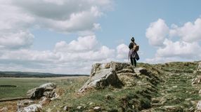 Girl hiking in Northumberland National Park during a stay of England in 4 days.