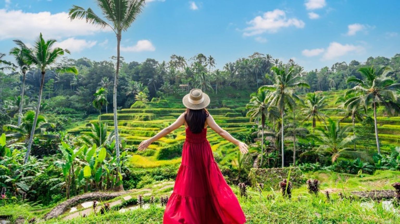 A girl in red dress in rice terraces during her 9 days in Indonesia.