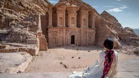 An Asian woman admiring the beauty in Petra; how many days to spend in Jordan.