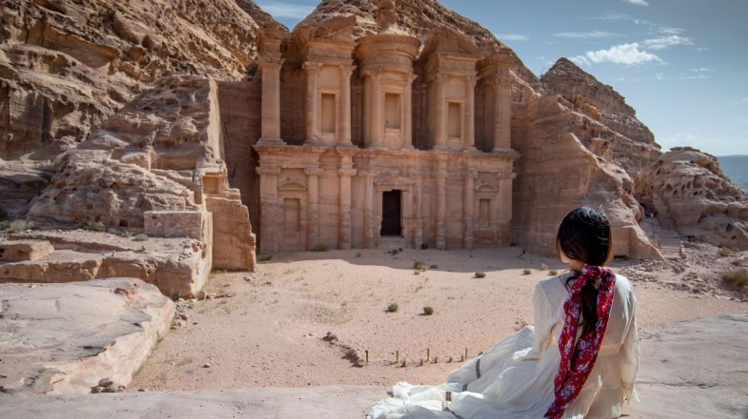 An Asian woman admiring the beauty in Petra; how many days to spend in Jordan.
