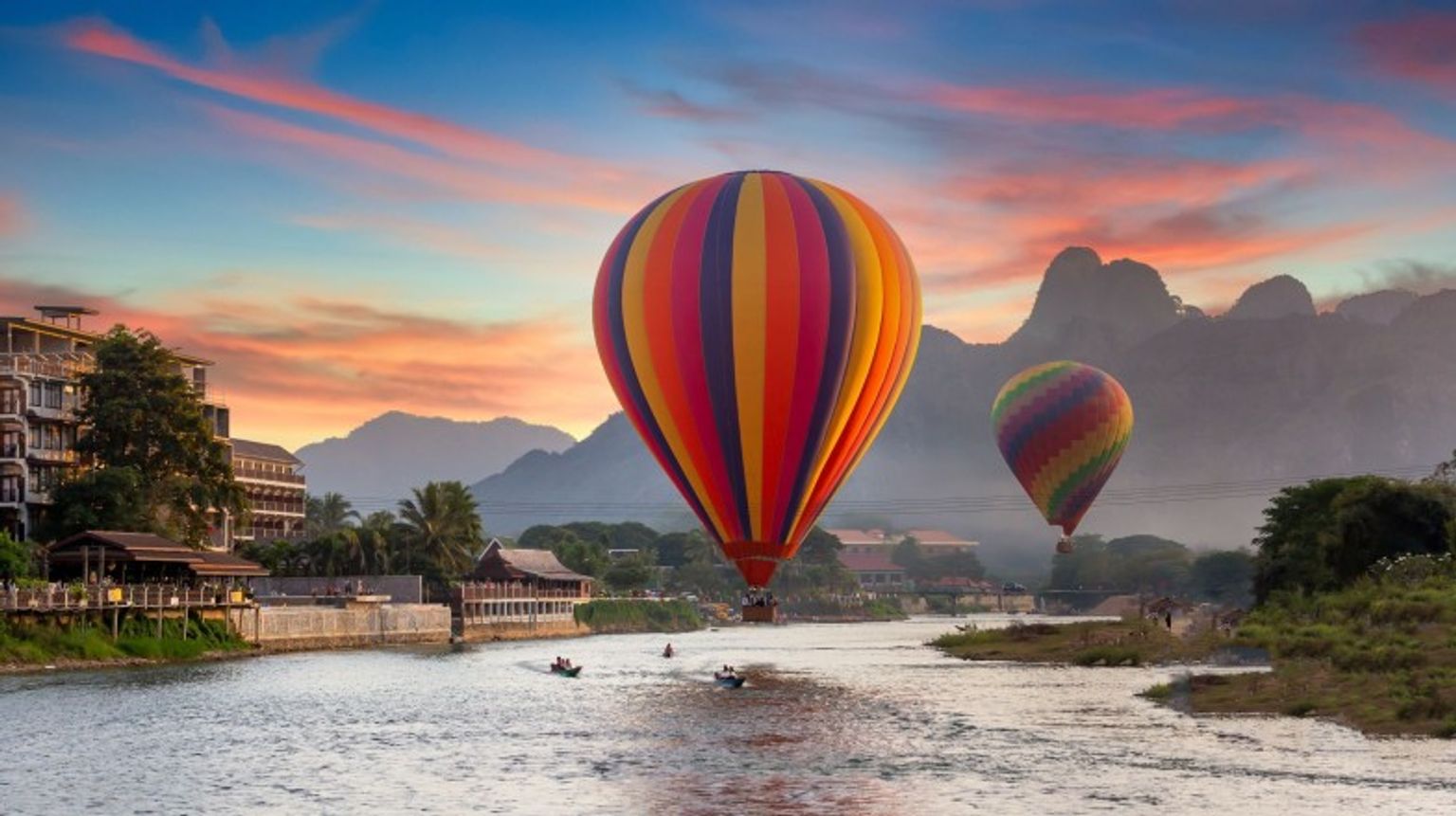 Enjoy the Nam Song river at sunset during your 2 weeks in Laos.