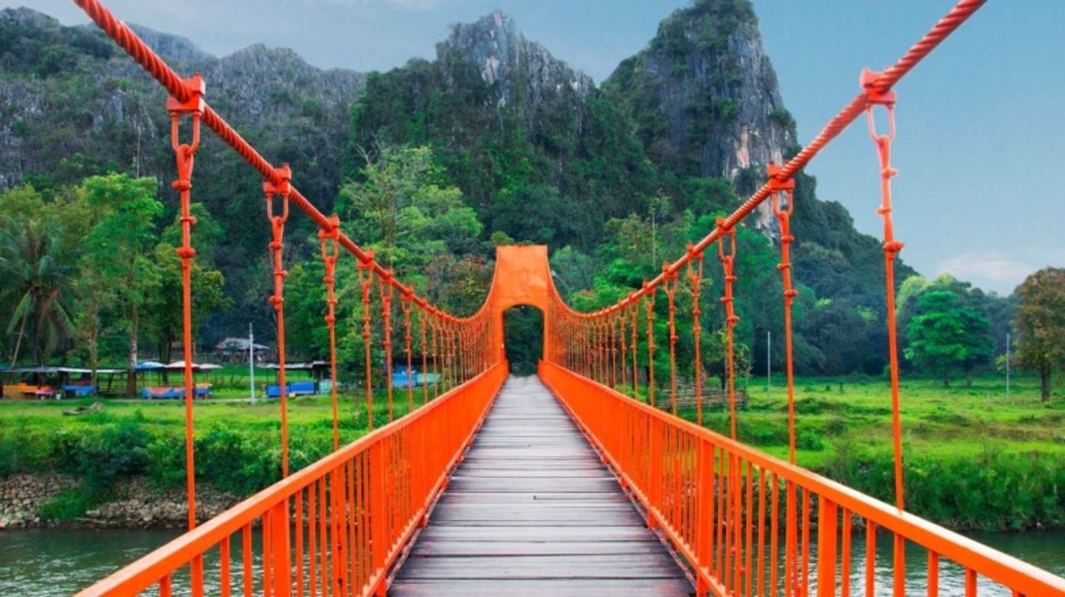 The orange bridge in Vang Vieng, often referred to as the "Nam Song Bridge," is a popular pedestrian bridge providing picturesque views of the surrounding landscape. Cross the iconic orange bridge in Vang Vieng during your 5 days in Laos.