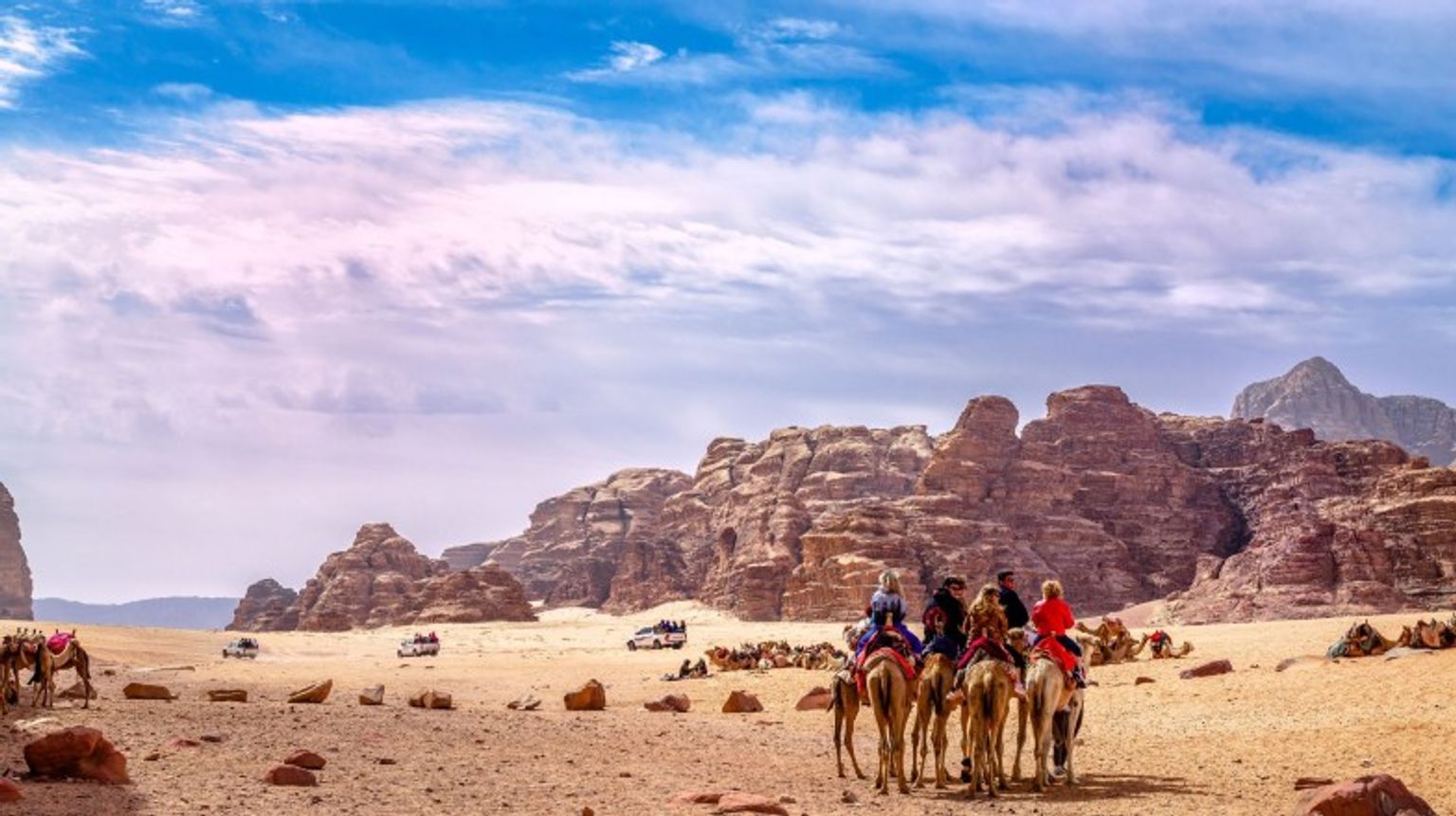 Tourists enjoying camel rides in Jordan in May.