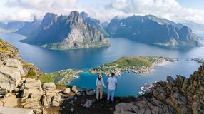 A couple admiring the beauty of Lofoten Island during their 2 weeks in Norway.