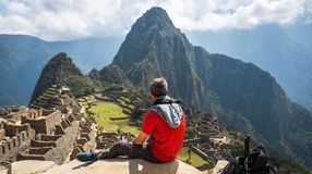 A tourist admiring the beauty of Machu Picchu on his one week in Peru adventure.
