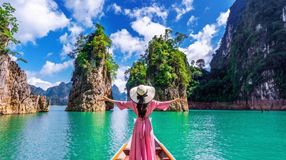 A woman with open arms on a bot in Khao National Park in Thailand in January.