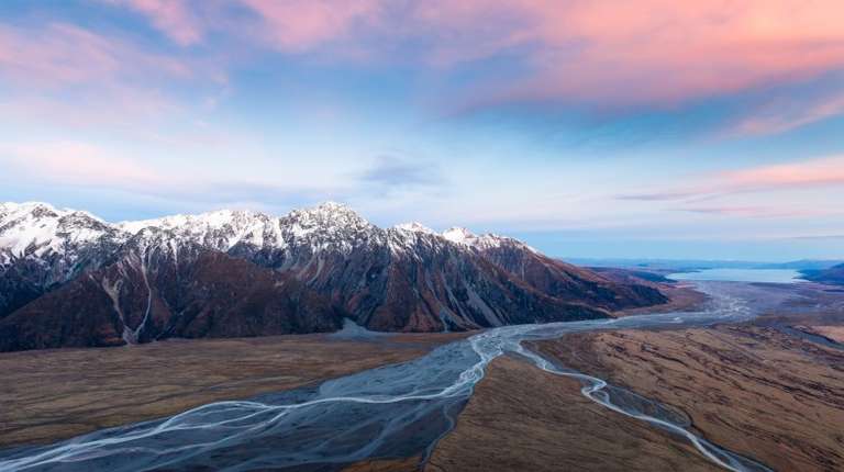 Aoraki Mount Cook National Park in winter in New Zealand with red clouds.