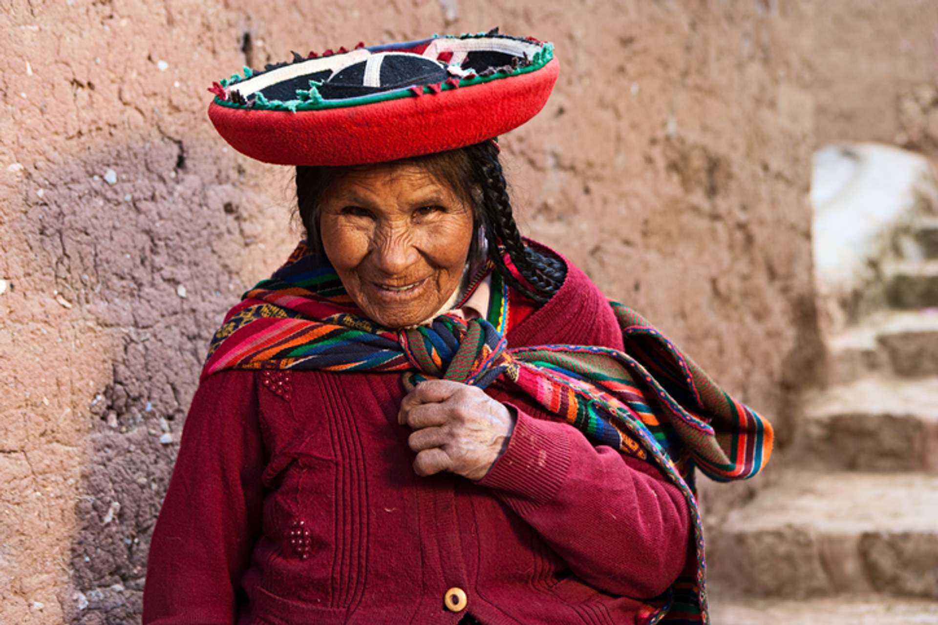 A portrait of an old Peruvian woman in traditional clothing