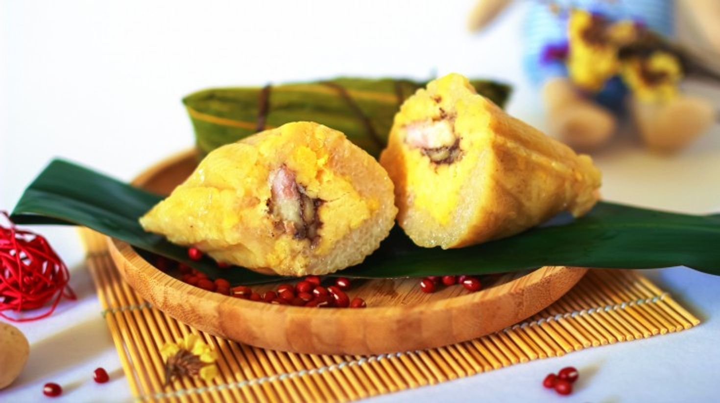 Yellow colored dish made of stuffed rice on bamboo leaves