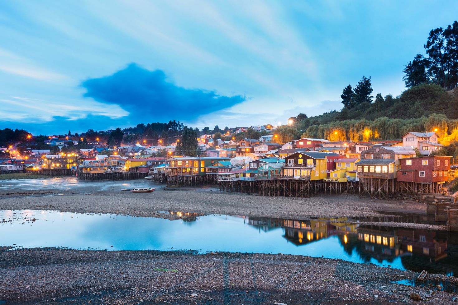 Chiloe's houses illuminated during sunset.