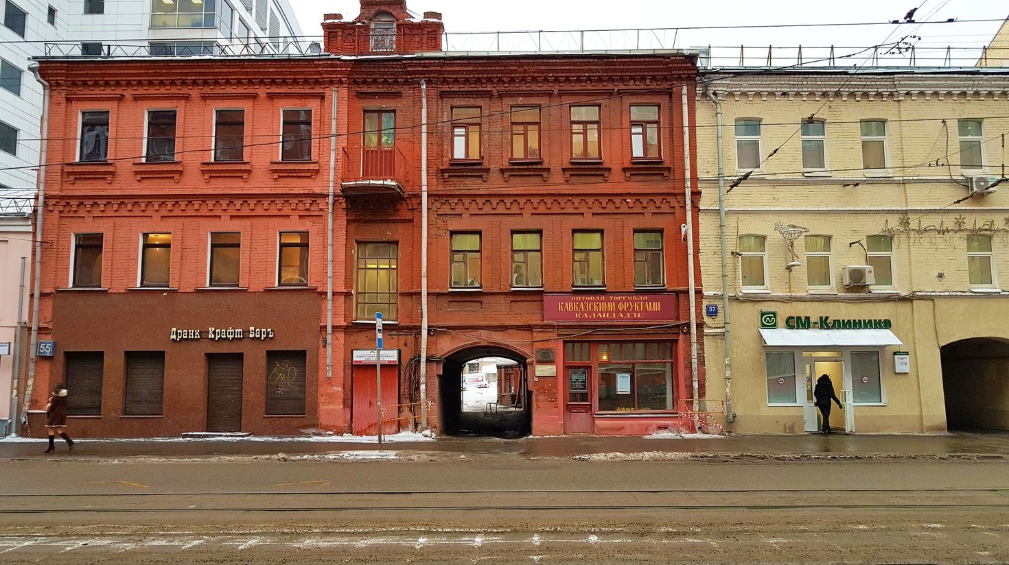 View of red and yellow colored buildings from across the street
