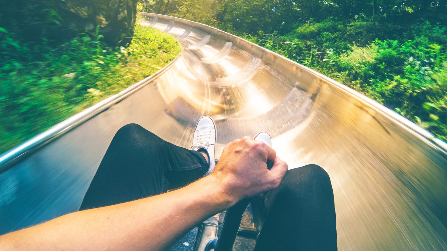 A man sliding down a slide on a toboggan
