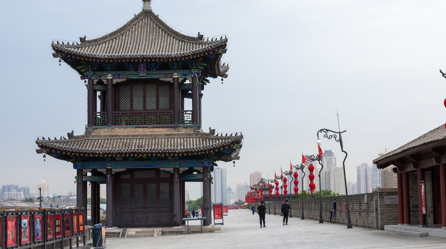 A traditional structure building with people walking nearby