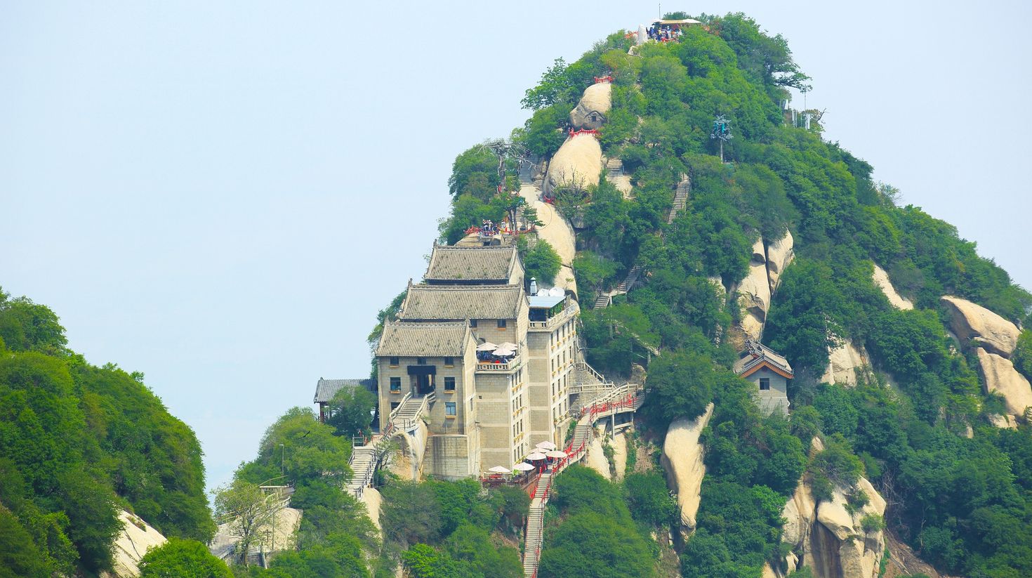 A view of ancient buildings and narrow stairs atop a hill