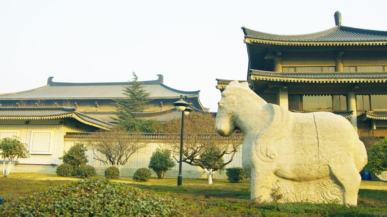 A view of traditional house complex with a horse sculpture in its yard