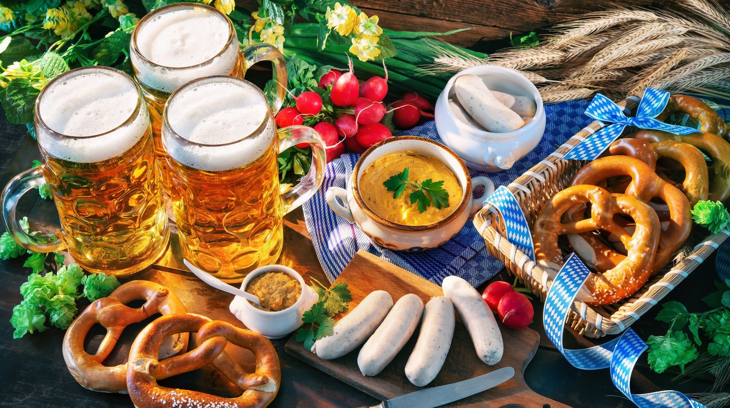Oktoberfest menu involving Bavarian sausages with pretzels and beer.