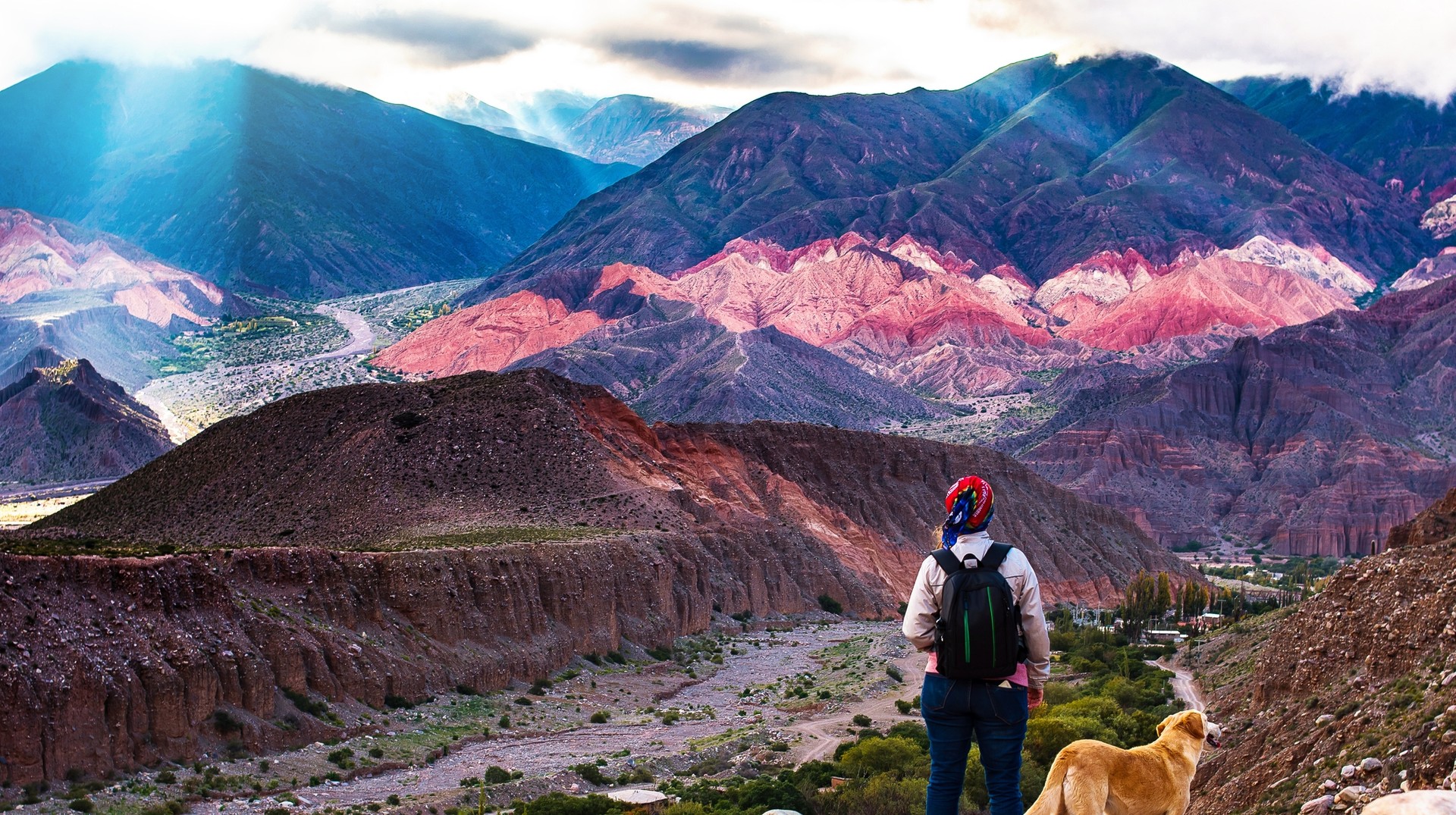 Trek the mountains and take in the beauty of the country during your 2 weeks in Argentina trip. A trekker girl with her dog admiring the landscapes of the country during her 2 weeks in Argentina.