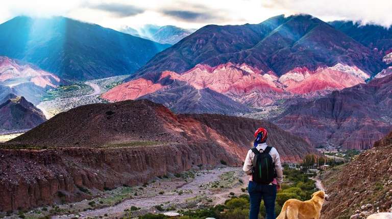 A trekker girl with her dog admiring the landscapes of the country during her 2 weeks in Argentina.