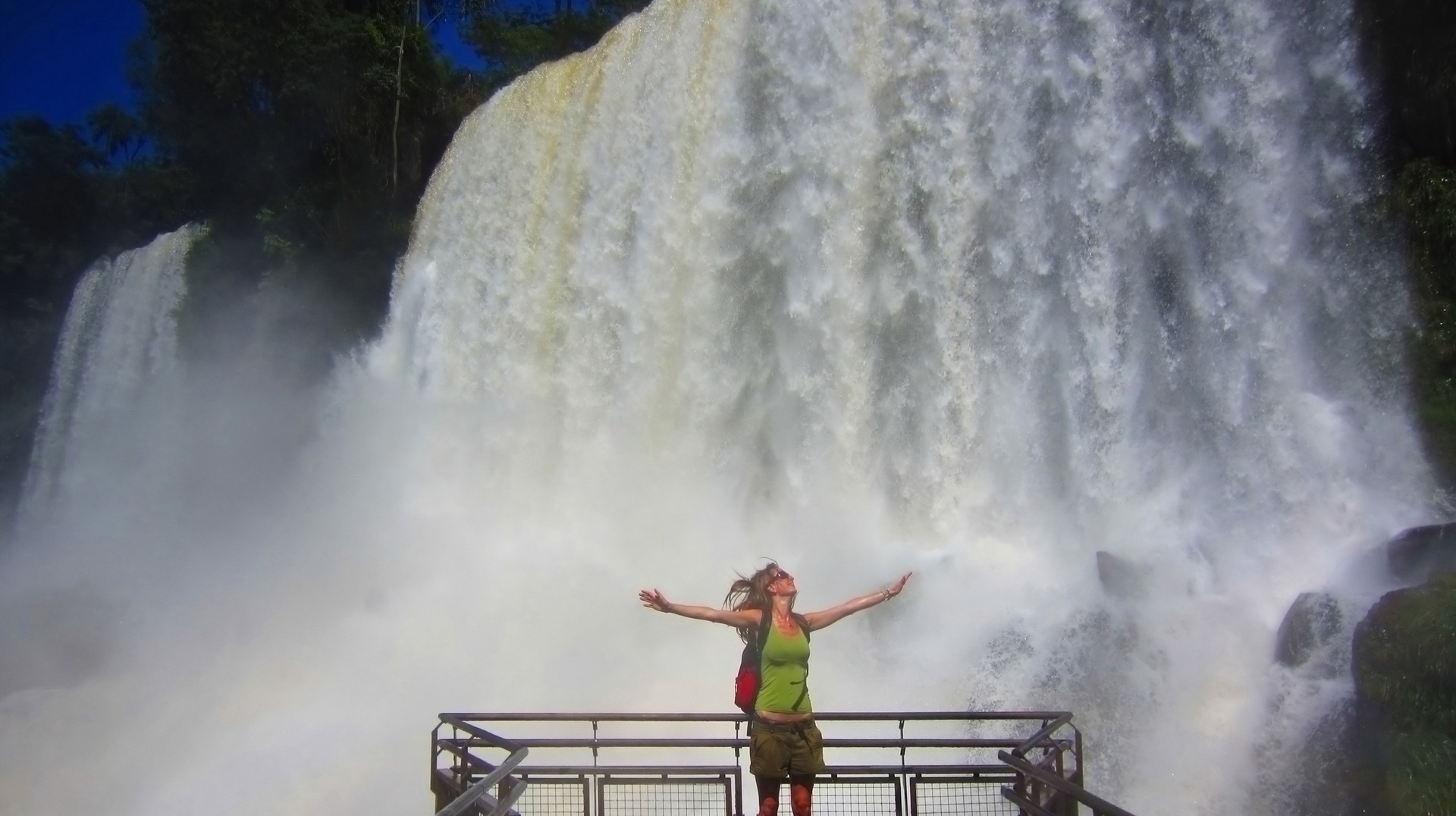 A tourist girl admiring the magnificence of Iguazu Falls during her 3 weeks in Argentina.