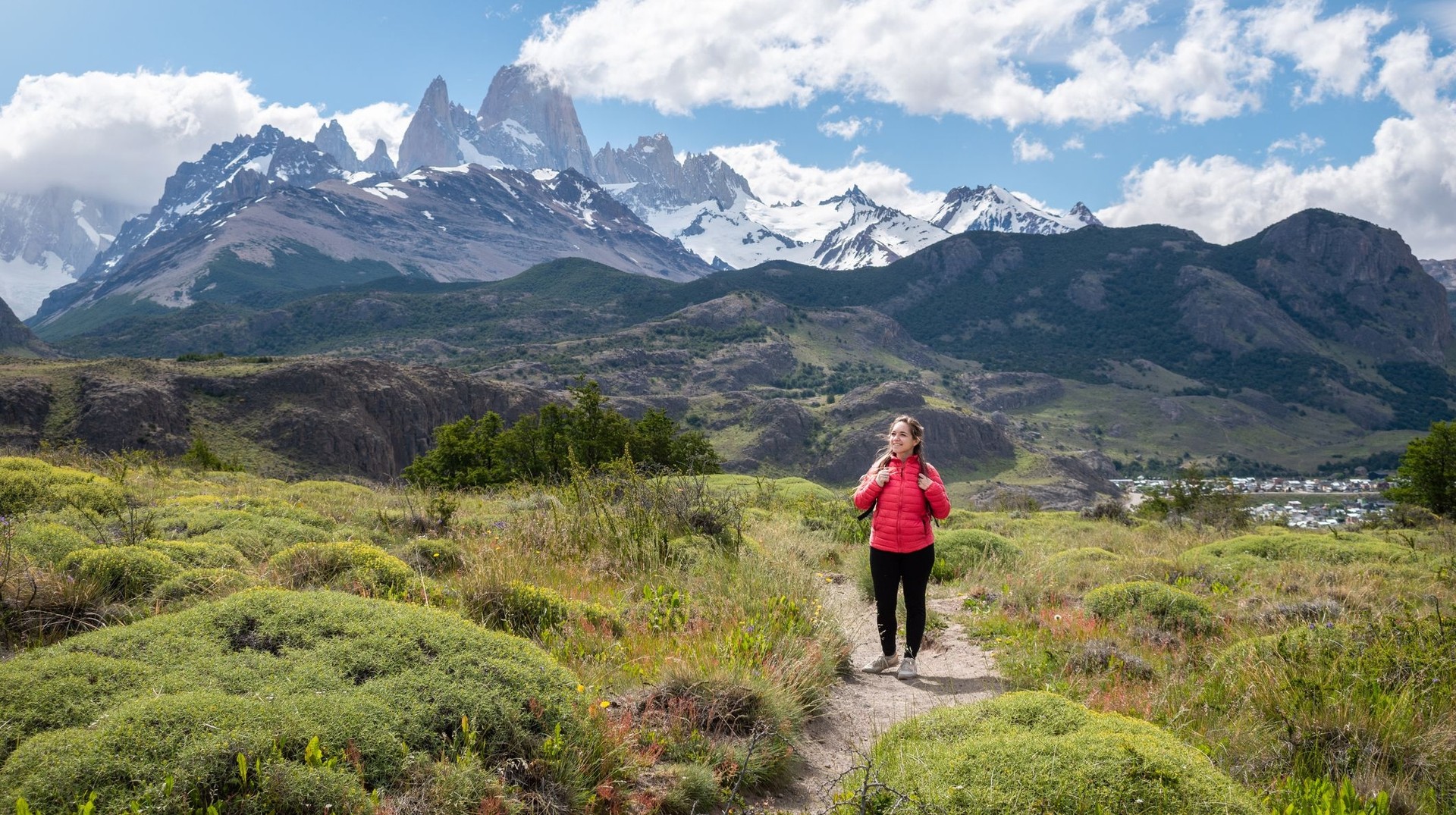 Hike through stunning landscapes during your Argentina in December trip, from the Andes to serene lakes and valleys. A young hiker with Mount Fitz Roy at the back during her trip to Argentina in December.