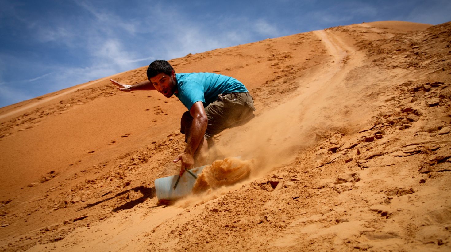 Sandboarding down the sand dunes in the Death Valley
