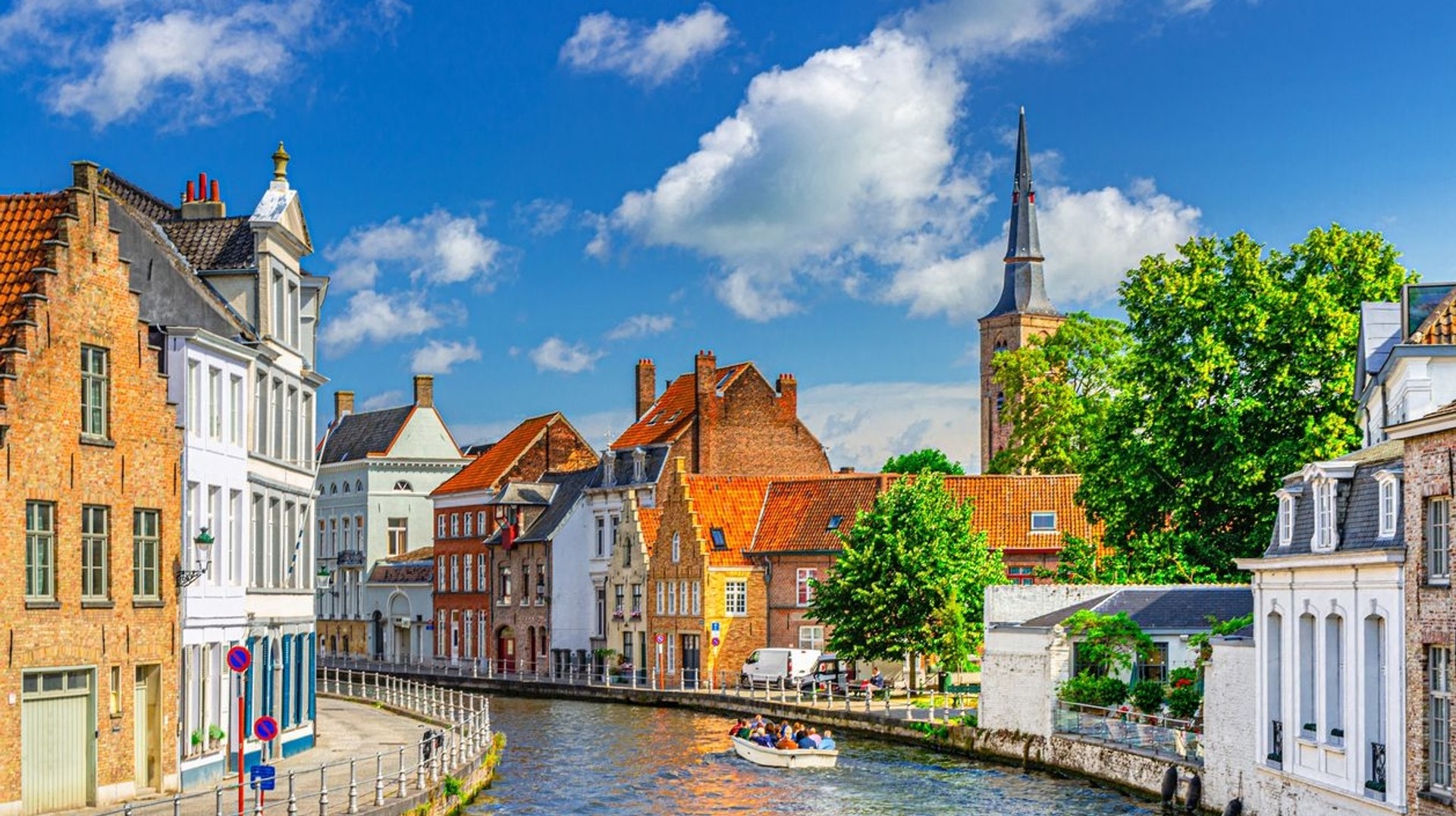 During your five days in Belgium, be sure to boat through the icnonic Sint Annarei water canal in Brugge. Tourists boating in Sint Annarei water canal during their 5 days in Belgium.