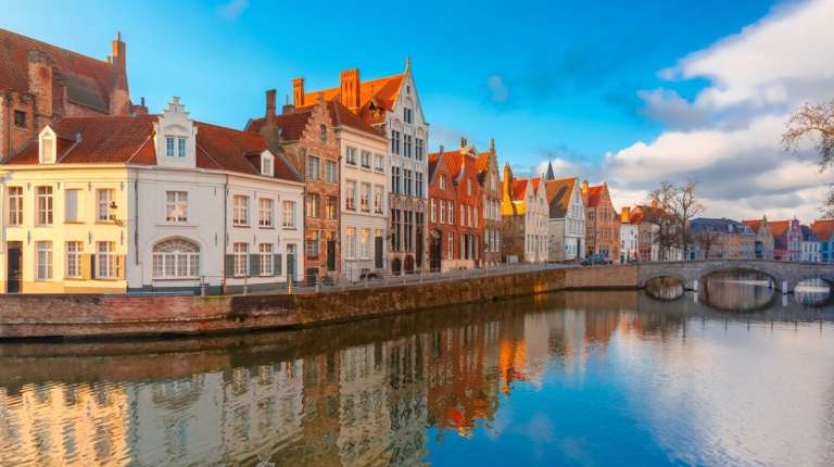 Bruges canal with medieval houses and their reflections in Belgium in May.