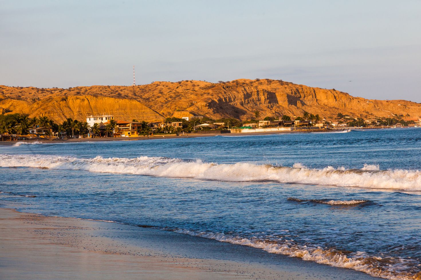 A view of Mancora beach with hills in the background. 