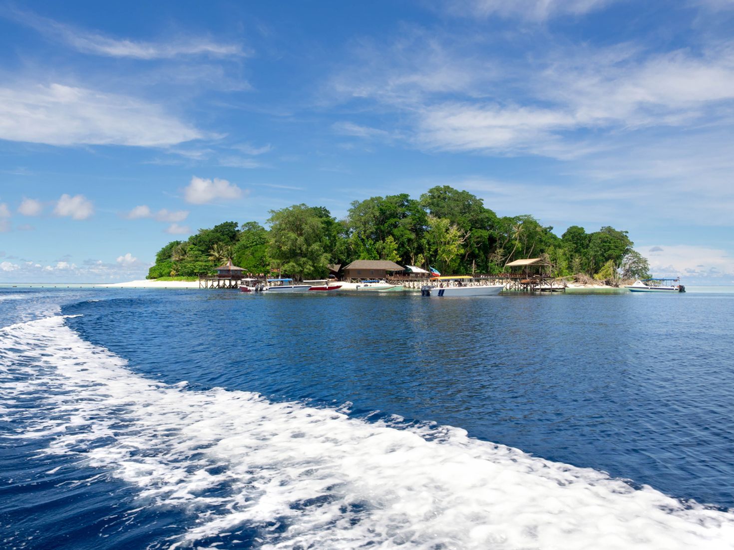 Sipadan island with boats in the water during the day.