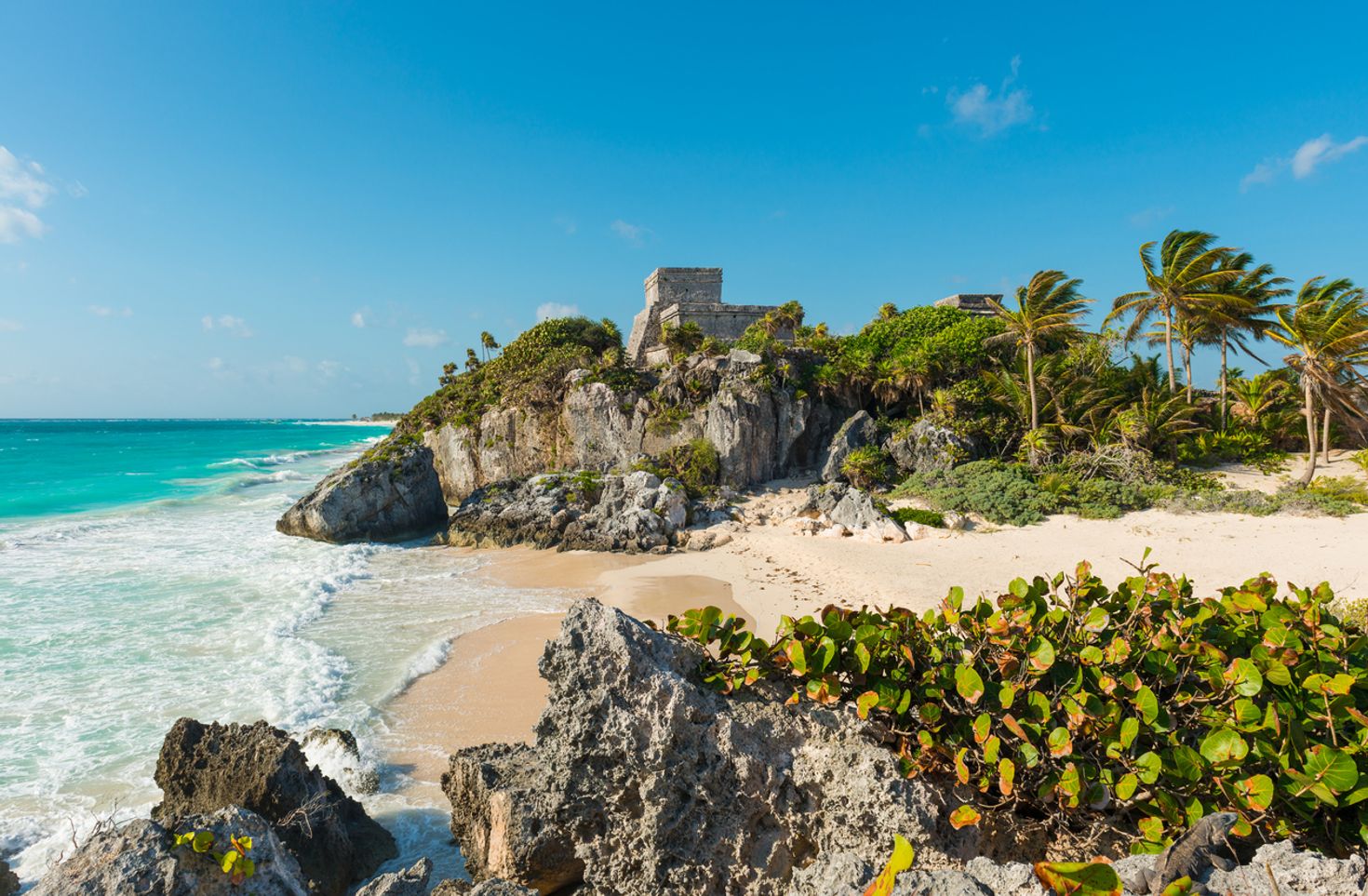 Mexico's Tulum beach with trees, hills and water. 