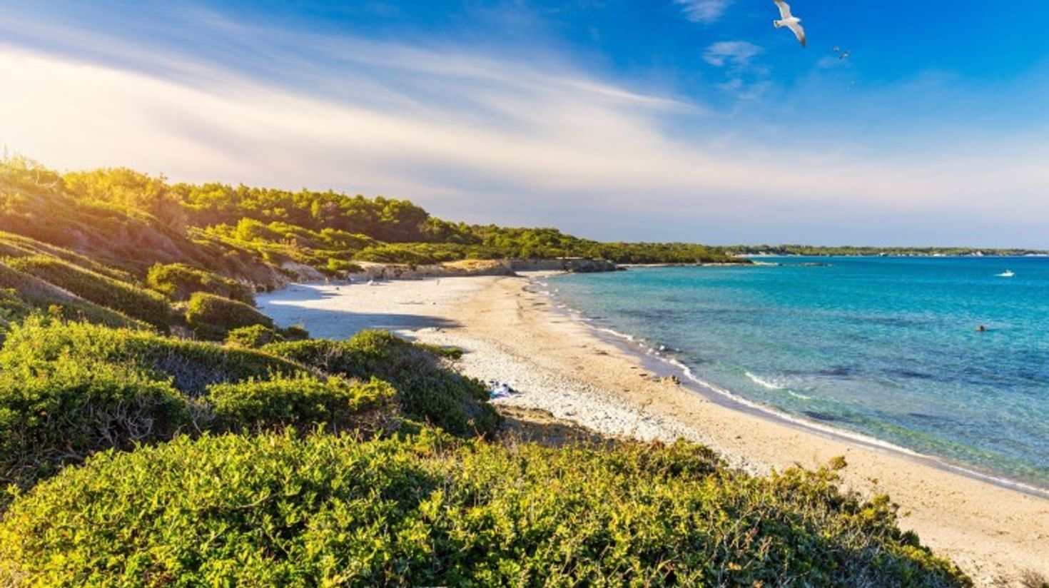 The view of Baia dei Turchi during sunset in Italy.