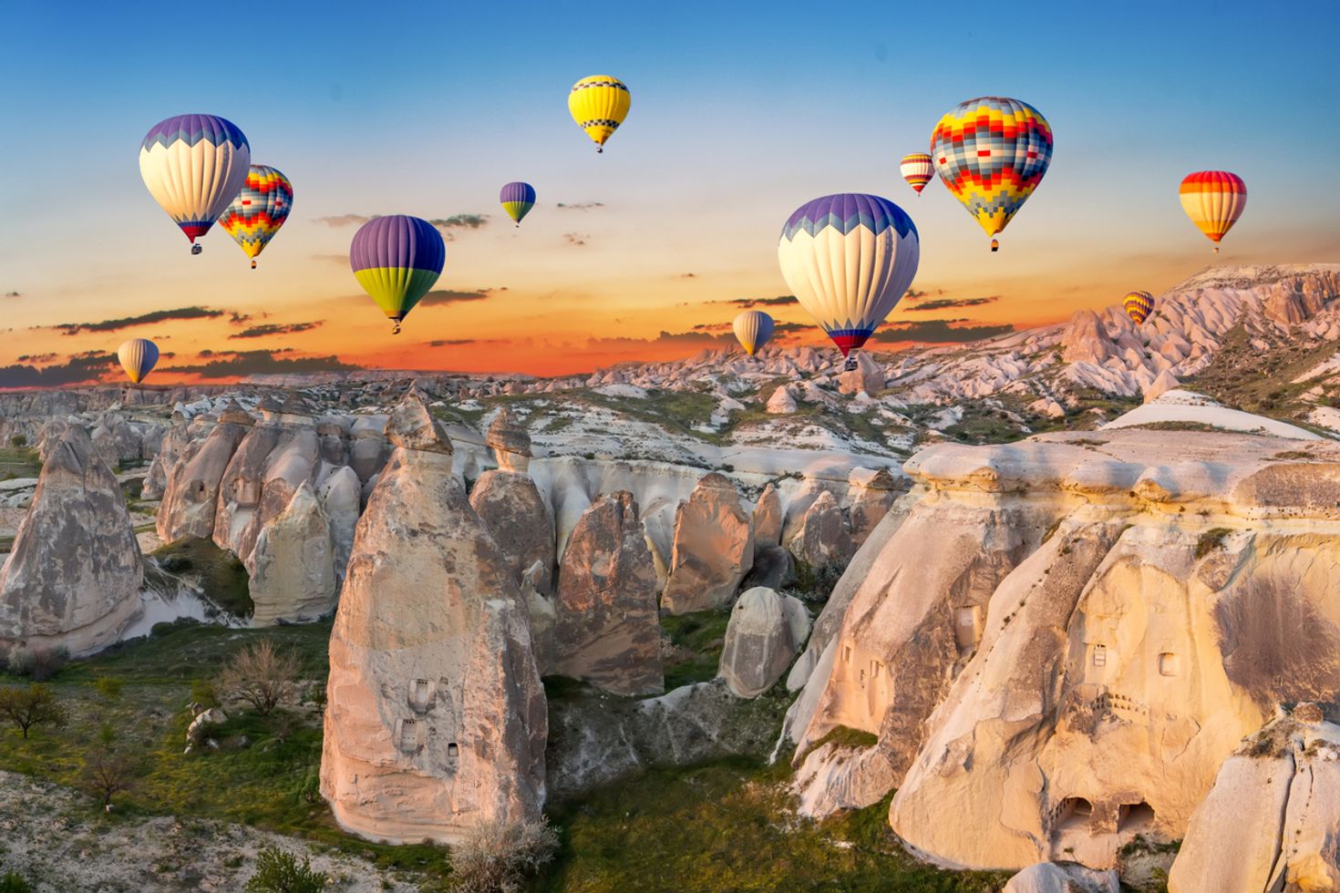 Hot air balloons in the sky over the landscape of Cappadocia in Turkey.