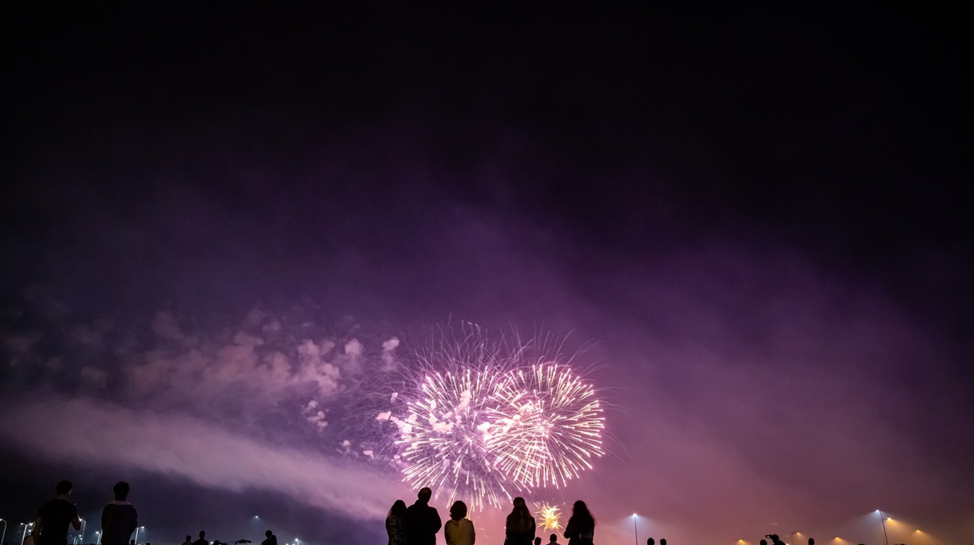 The best places to spend New Year's have one thing in common: the spectacular fireworks shows when the clock strikes midnight on Jan 1. People watching fireworks show in one of the best places to celebrate New Year's.