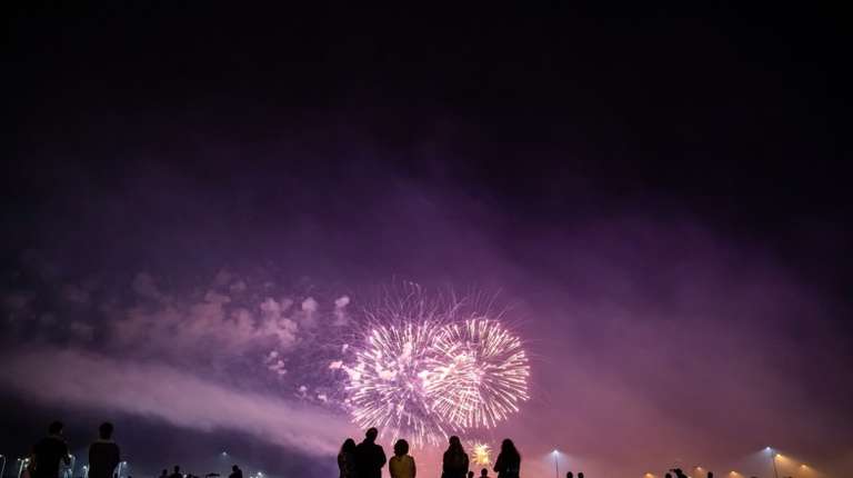 People watching fireworks show in one of the best places to celebrate New Year's.