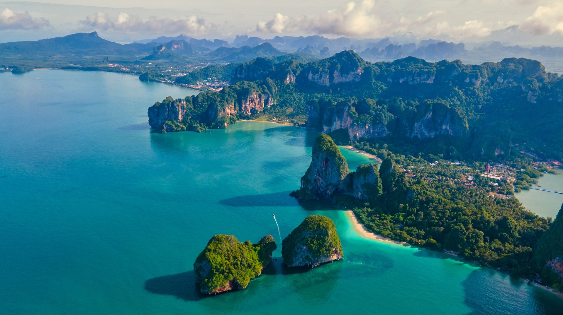 From autumnal season in the north to spring transitions in the south, September is one of the best time to travel to your favorite destinations. Aerial view of an island with huge limestone rocks and lush green trees surrounded by turquoise water during the day.