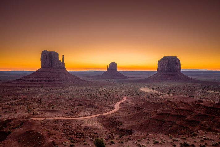 An evening view of the Grand Canyon with orange sky. 