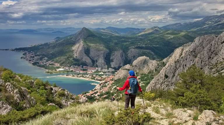 A woman hiking on the Adriatic coast, which is one of the top things to do in Croatia.