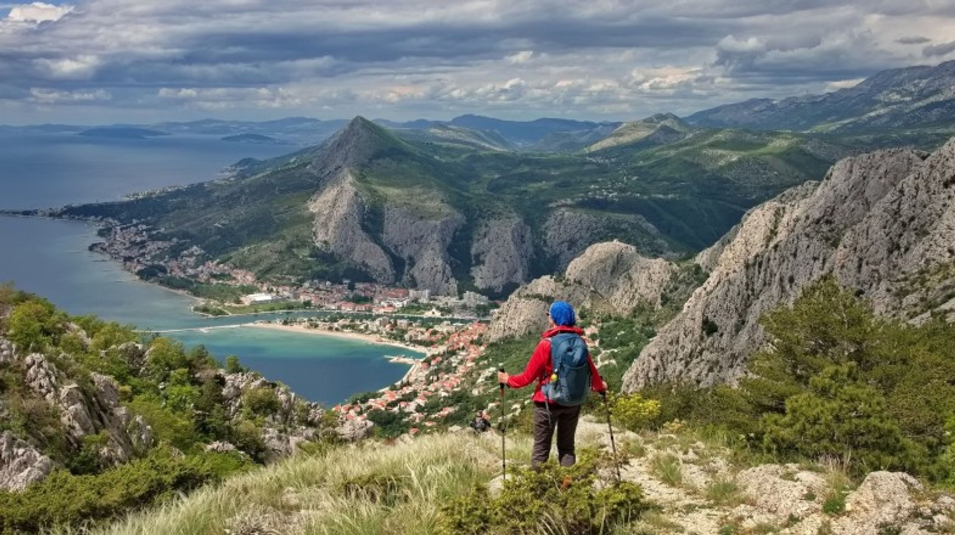 Hike through stunning landscapes, a must on your list of top things to do in Croatia. A woman hiking on the Adriatic coast, which is one of the top things to do in Croatia.